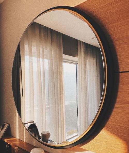 mirror displaying Where to Hang Curtain Rods