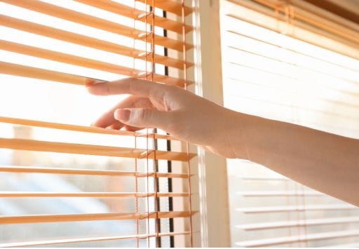 a hand showing how to fix cordless blinds broken slates