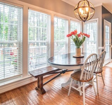 white blinds along with 3 strings in the living room
