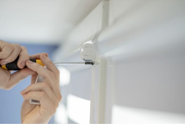 a person is reinstalling Levolor blinds