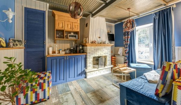 A blue-themed living room showcasing how to use curtain rings without clips to enhance aesthetics
