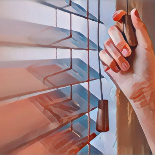 A hand is testing the mini blinds