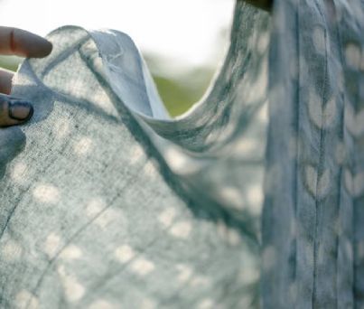 A woman cleaning spots visible on the curtain.